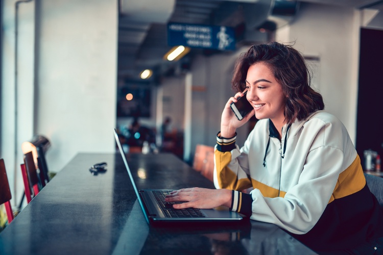 woman on phone at computer